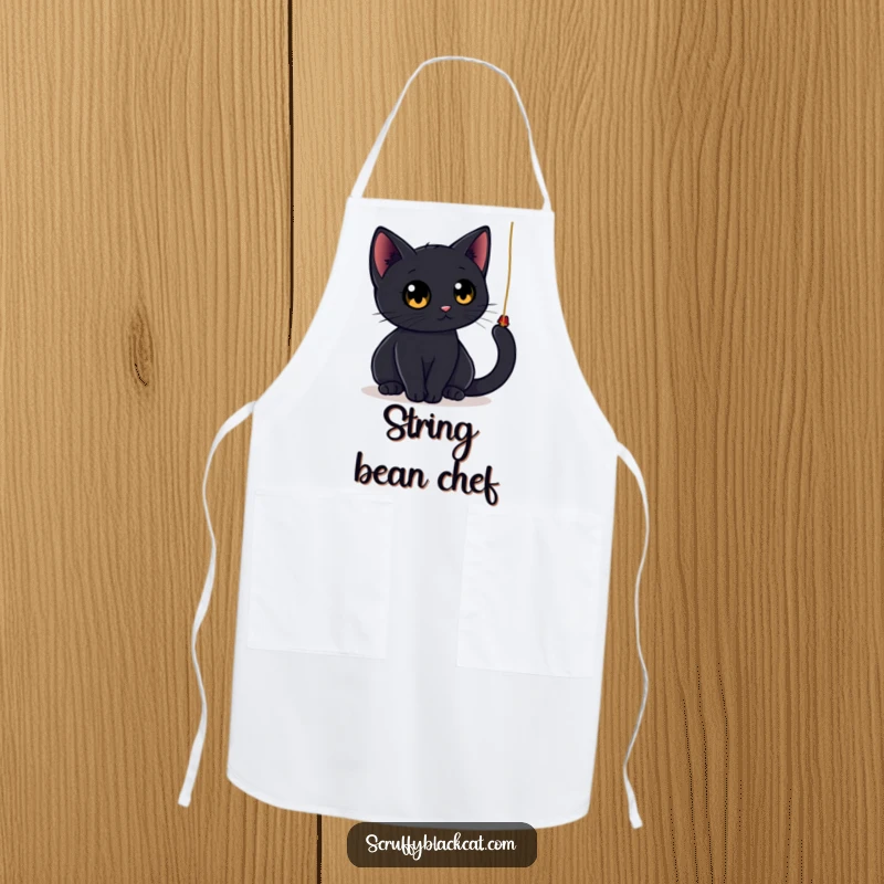 Funny black cat apron showing a sleek cat with large, round eyes playfully batting at a dangling string, adding a humorous touch to kitchen activities.
