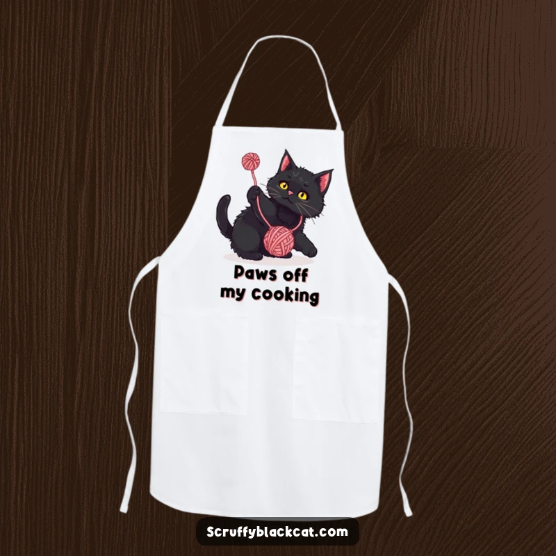 Funny Apron: Scruffy black cat playfully batting at a dangling yarn ball, a humorous and functional kitchen accessory.