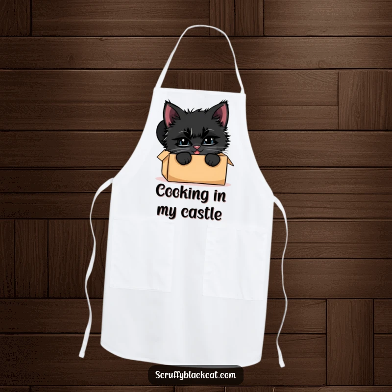 Funny black kitten apron, illustrated peeking from a cardboard box with a wide, mischievous grin, ready for fun.