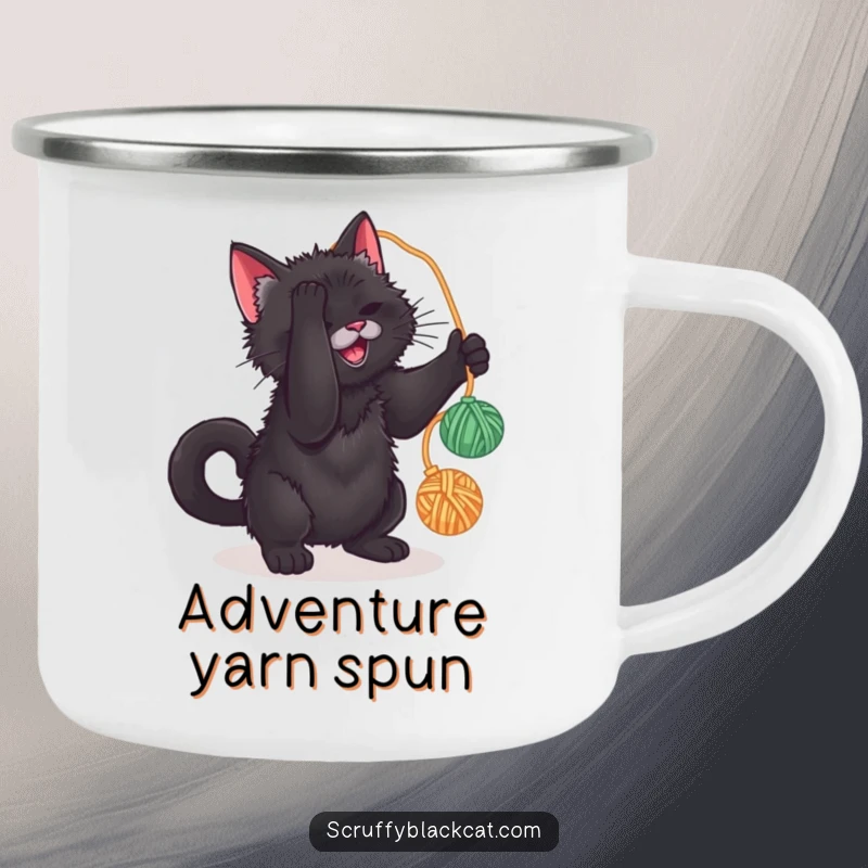 Funny camping mug featuring a scruffy black cat batting at a yarn ball, perfect for outdoor enjoyment and humorous sipping.