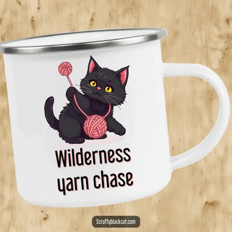 Funny Camping Mug: Scruffy black cat playfully batting at a dangling yarn ball, a durable and humorous camp essential.