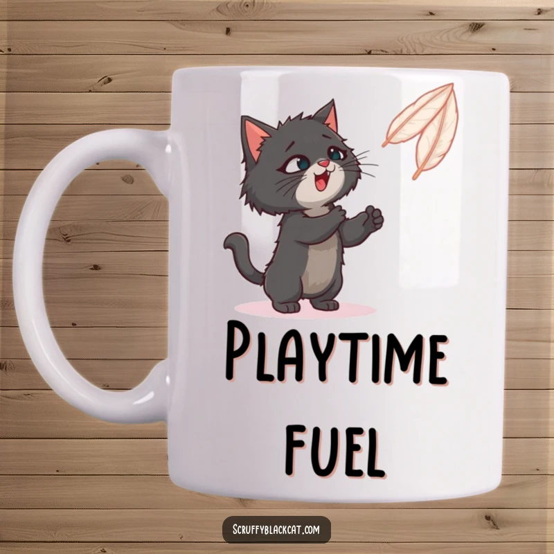 Funny mug: A scruffy black cat playfully bats at a brightly colored, bouncing feather toy.