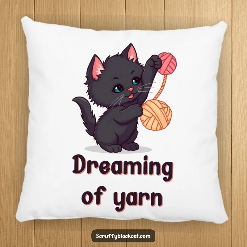 Funny kitten pillow featuring a scruffy black kitten batting at a dangling yarn ball, for cozy, humorous moments.
