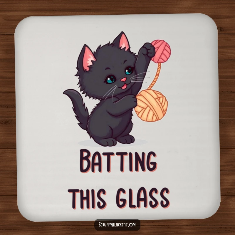 Funny kitten coaster showing a scruffy black kitten batting at a dangling yarn ball, for humorous surface protection.