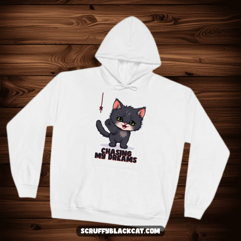 Funny hoodie depicting a scruffy black kitten chasing and batting at a dangling string, radiating cozy cuteness.