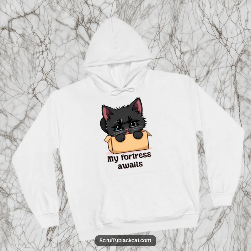Funny scruffy black kitten hoodie, peeking curiously from a cardboard box, sporting a very mischievous grin.