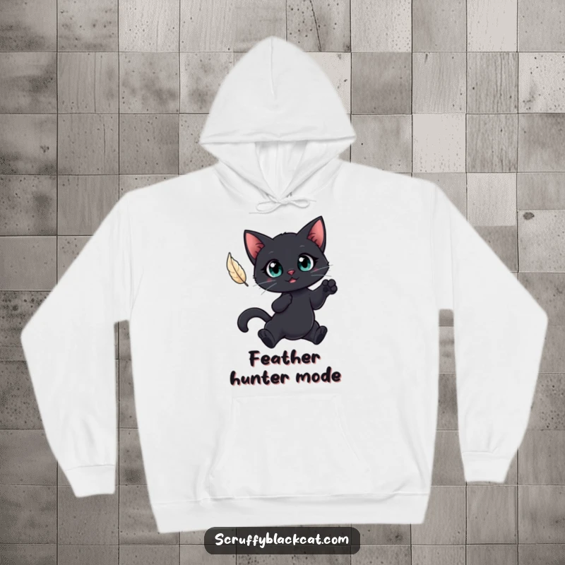 Funny hoodie with a big-eyed black cat mid-leap for a feather, offering warmth and humorous, playful intensity.