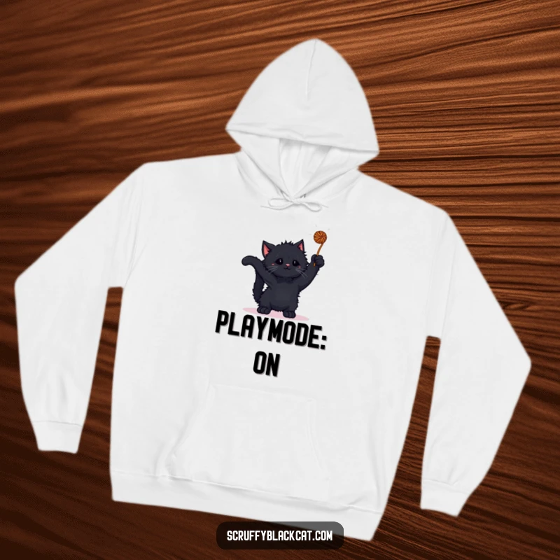 Funny kitten hoodie featuring a scruffy black kitten batting at a yarn ball, emphasizing warmth and playfulness.