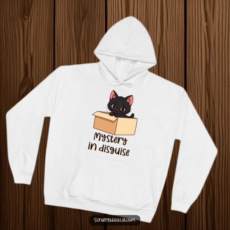 Funny hoodie depicting a mischievous black kitten peeking from a shadowy box, offering cozy intrigue.