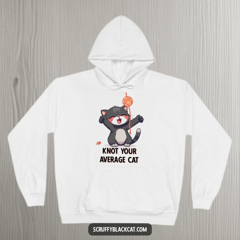 Funny scruffy black cat hoodie, playing with a yarn ball, eyes full of delight, super soft and comfy, a hilarious gift.