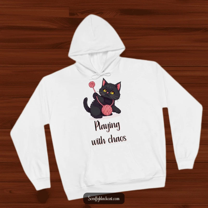 Funny Hoodie: Scruffy black cat playfully batting at a dangling yarn ball, a warm and humorous apparel for cat enthusiasts.
