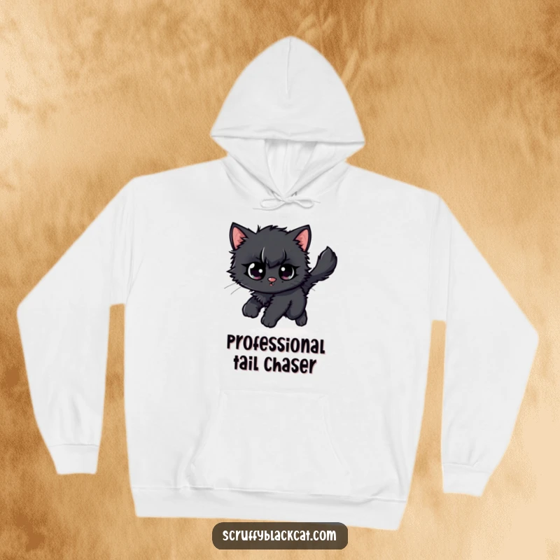 Funny scruffy black kitten hoodie, showing it hilariously chasing its own fluffy tail with wide, cartoonish eyes.