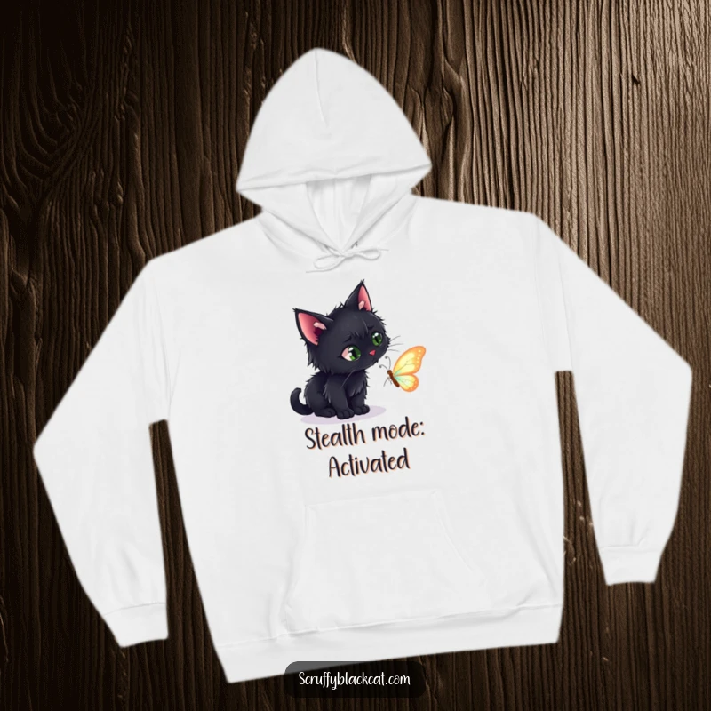 Funny hoodie showcasing a scruffy black cat with intense focus, about to pounce on a delicate, shimmering butterfly.