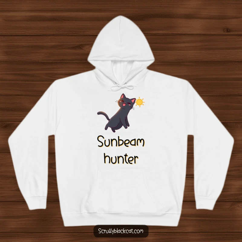 Funny hoodie with a black cat leaping playfully after a bright, dancing sunbeam, radiating warmth and happiness.