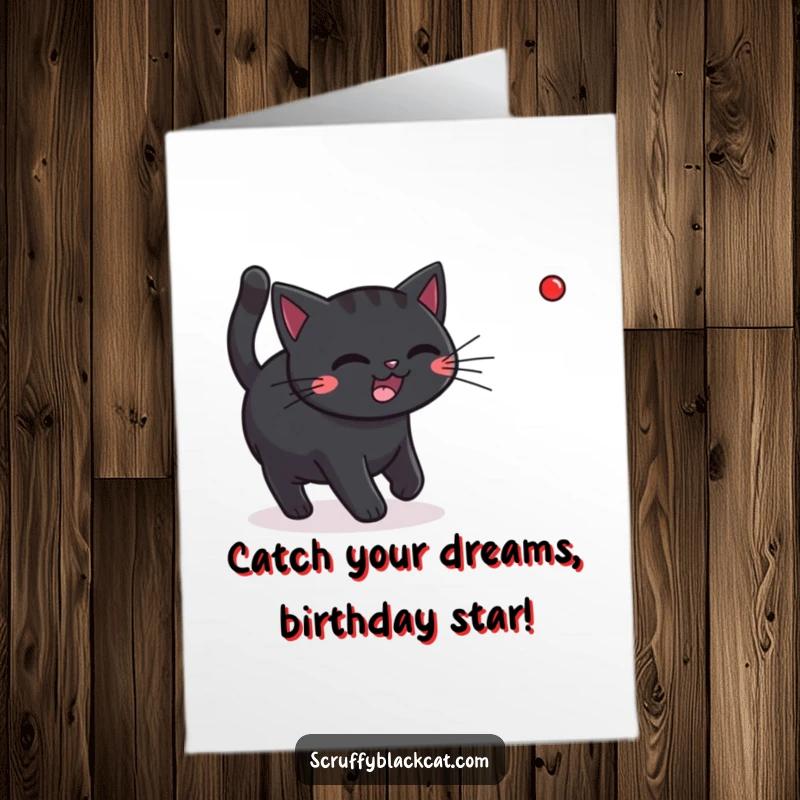 Funny Free Printable Birthday Card: A happy black cat intensely chasing a bright red laser pointer dot.