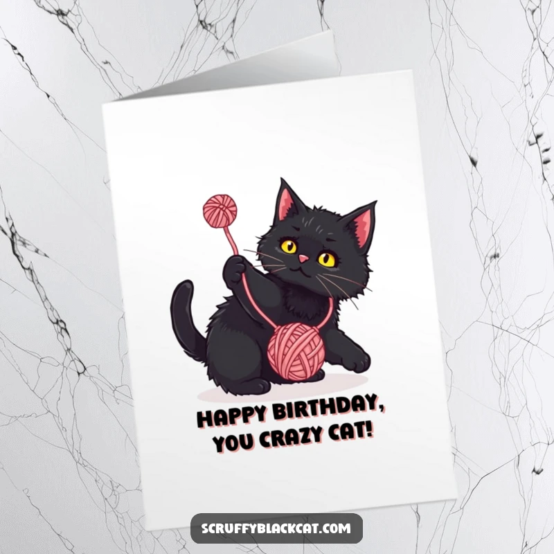 Funny Free Printable Birthday Card: Scruffy black cat playfully batting at a colorful dangling yarn ball, pure feline joy.