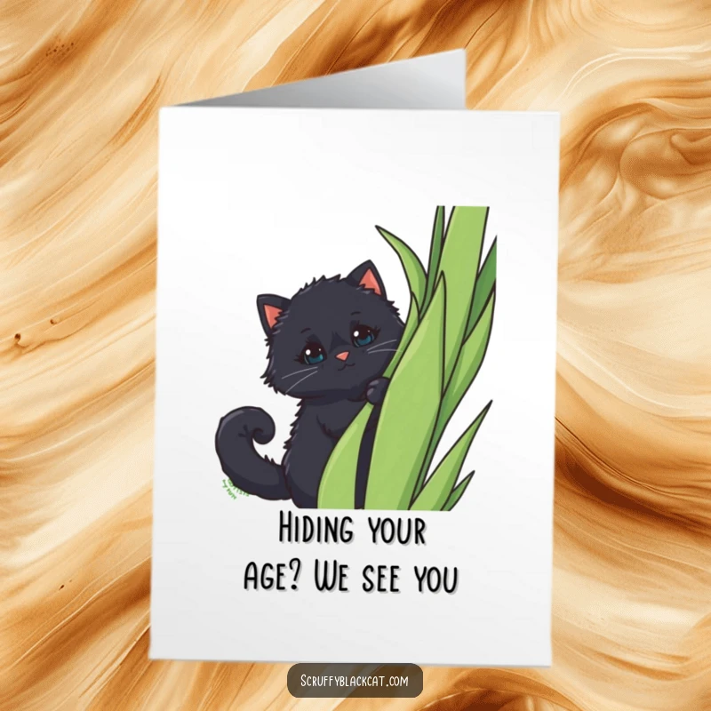 Funny Free Printable Birthday Card: Fluffy black cat with a curled tail peeking mischievously from behind a tall green plant.