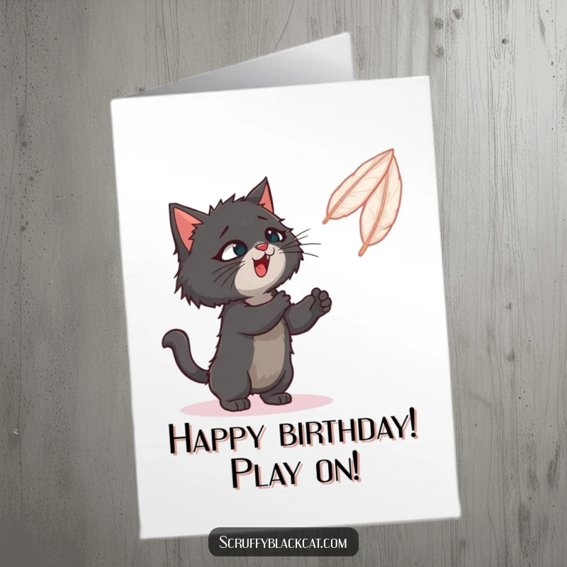 Funny Free Printable Birthday Card: Scruffy black cat excitedly swatting at a brightly colored bouncing feather toy.