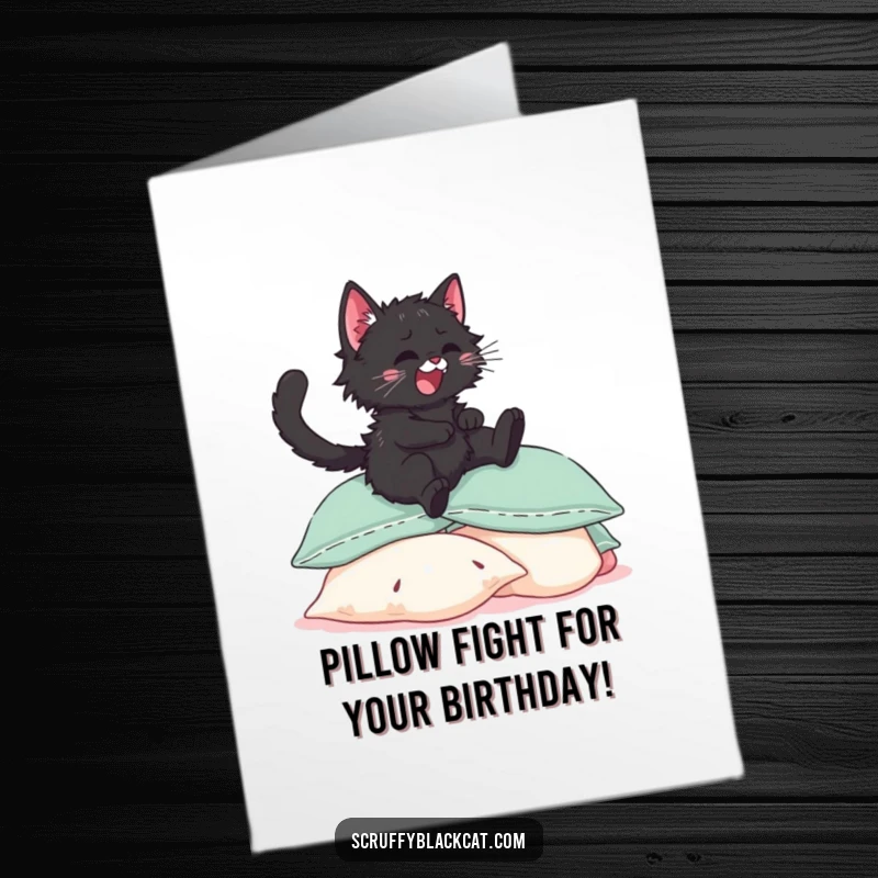 Funny Free Printable birthday card: A scruffy black kitten joyfully leaps high onto a stack of plush pillows, pure bliss captured.