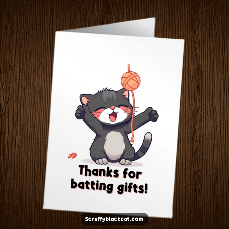 Funny free printable thank you card: a scruffy black cat batting playfully at a dangling yarn ball, a cute way to say thanks.