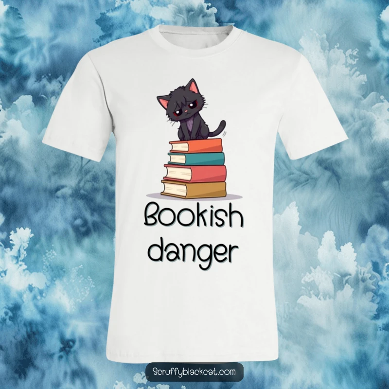 Funny t-shirt featuring a scruffy black cat attempting to balance on a tall, teetering stack of books.