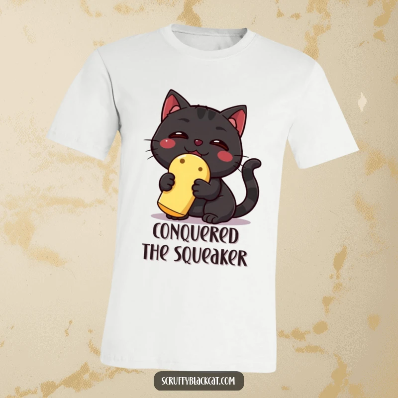 Funny Black Cat T-Shirt: A victorious black cat proudly displays a squeaky toy, exuding a hilarious sense of accomplishment and pure joy.