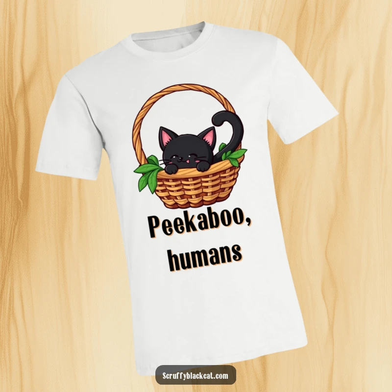 Funny t-shirt graphic of a black cat with an alert, wagging tail peeking curiously from within a cozy basket, embodying playful stealth.
