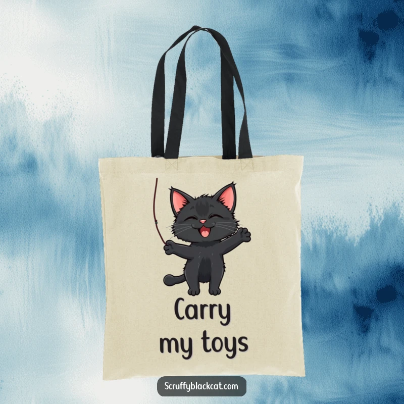 Funny Cat Tote Bag showcasing a scruffy black cat batting a dangling string, perfect for carrying essentials with playful flair.