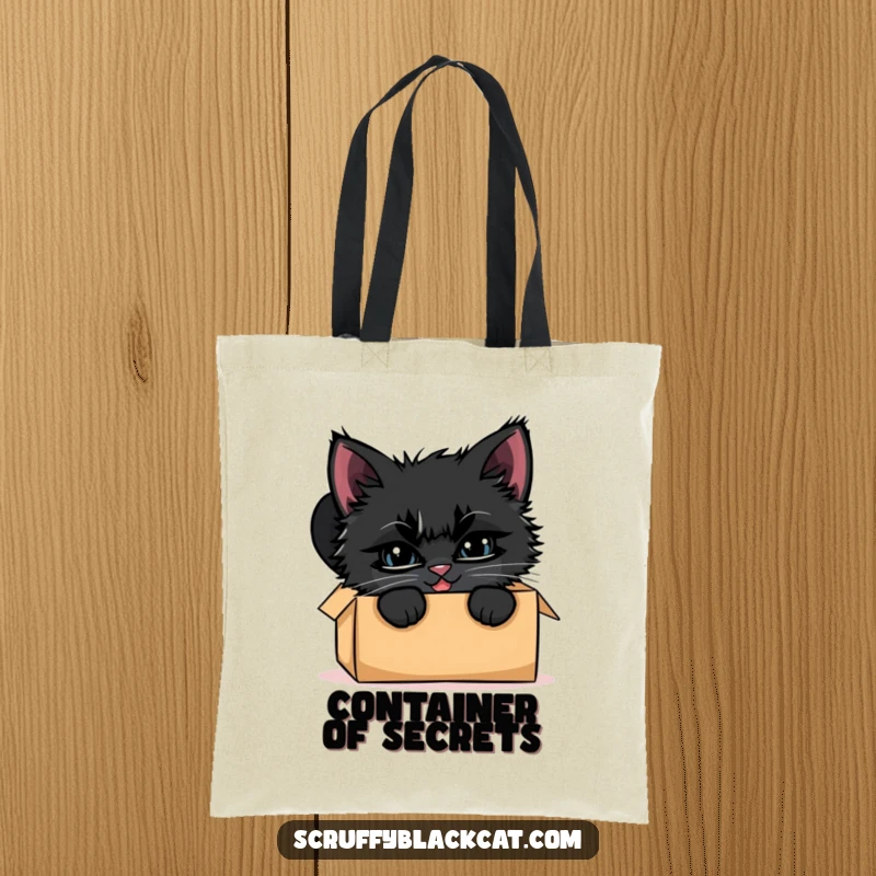 Funny black kitten tote bag, illustrated peeking from a cardboard box with a mischievous smile, embodying playful curiosity.