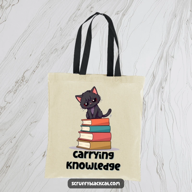 Funny tote bag showing a scruffy black cat balancing precariously on a stack of old books.