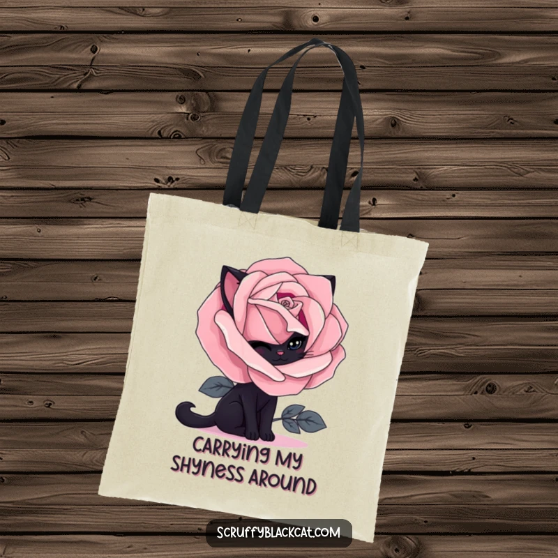 Funny black cat tote bag depicting a shy feline emerging from behind a blooming gothic rose, great for everyday use.